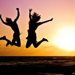 Silhouette of two people doing jump shot