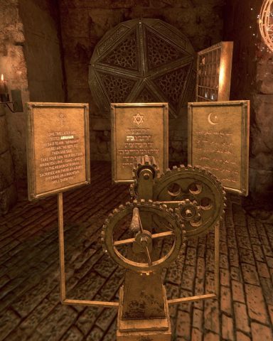 Three gears are mounted in front of metal panels with words etched upon them. From left-to-right, the panels are indicated with a Christian cross and English script, a Jewish Star of David with Hebrew script, and a Muslim star and crescent with Arabic script.