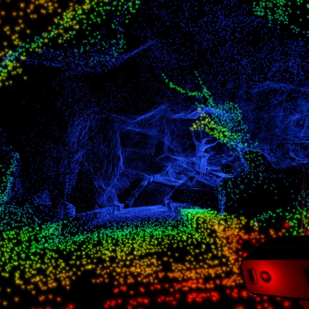 An image of the interior of a cavern made up of dots of various sizes and colors.